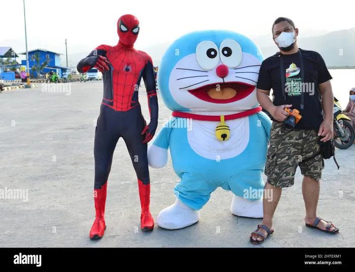 Man with a mask posing with Spiderman and Doraemon. Cosplay in Palopo,  Indonesia Stock Photo - Alamy